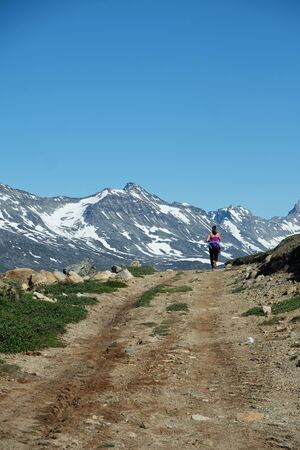 People jogging in the beautiful Tasermiut fjord in Greenlandの写真素材