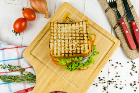 sandwich on a wooden board with vegetables, with herbs and vegetablesの写真素材