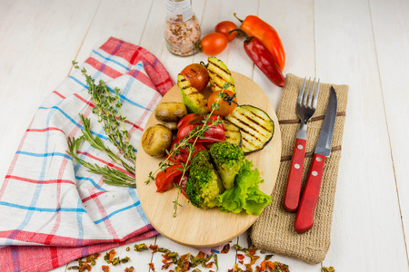 grilled vegetables on a wooden background with floats and greensの写真素材