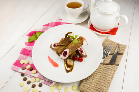 Sweet chocolate pancakes with cherriesの写真素材