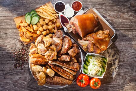 Myanoe arosti grill on wooden boards with fries and vegetables. The concept of grill, barbecue.の写真素材