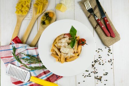 pasta with cheese on a wooden background with a linen towelの写真素材