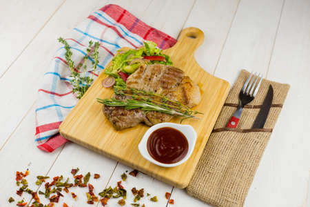 Grilled pork with gravy with vegetables and sauce
