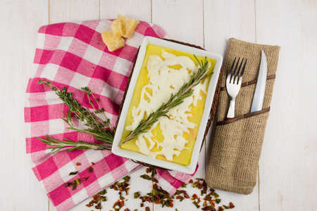 lasagna with rosemary cheese on wooden backgroundの写真素材