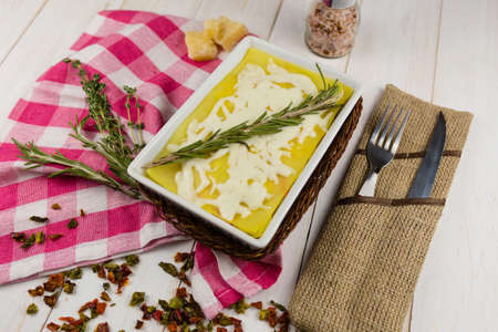 lasagna with rosemary cheese on wooden backgroundの写真素材