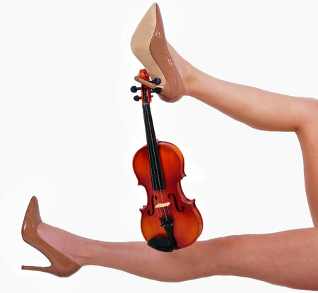 sexy legs girl holding violin isolated on white backgroundの写真素材