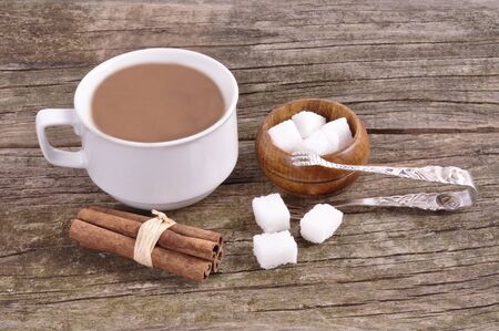 White mug with instant coffee and sugar bowl on an old wooden tableの写真素材