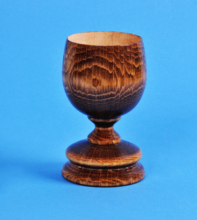 wooden wine glass on a blue backgroundの写真素材