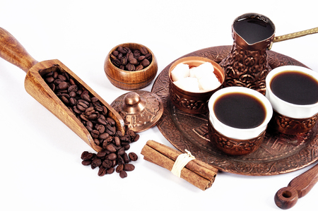 Coffee in copper coasters with accessories for coffee-drinking on a white backgroundの写真素材