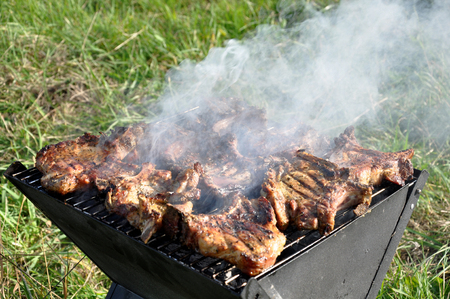Grilling at summer weekend. Fresh meat  preparing on grillの写真素材
