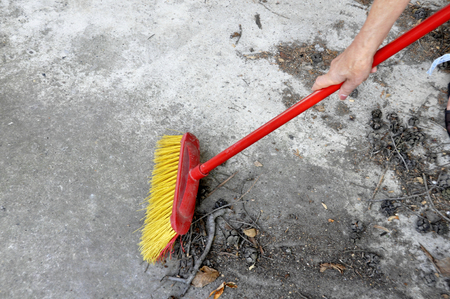 Image of red brush cleaning at garbage.の写真素材