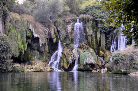Beautiful Kravica waterfall in Bosnia and Herzegovina - popular swimming and picnic area for tourists.の写真素材