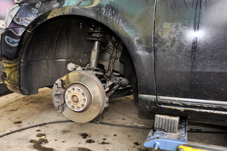 A close up view  brake disks and pads and wheel arch of  all wheel drive car when the tires have been taken off to be replaced.の写真素材