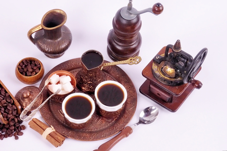 Coffee in copper coasters with accessories for coffee-drinking on a white backgroundの写真素材