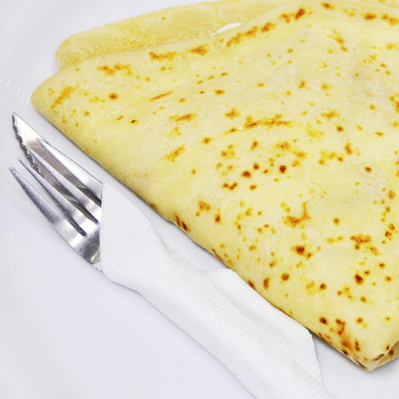 pancake served in a plate with a knife and forkの写真素材