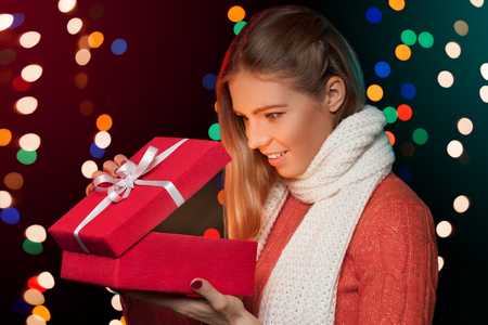 Happy girl opening Christmas box which is glowing inside. Christmas Giftの写真素材