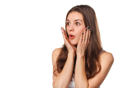 Surprised happy beautiful woman looking sideways in excitement, isolated on white backgroundの写真素材