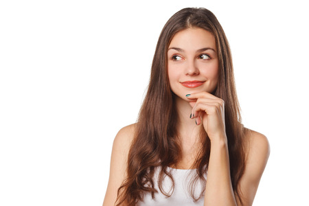 Young beautiful woman thinking looking to the side at blank copy space, isolated over white backgroundの写真素材