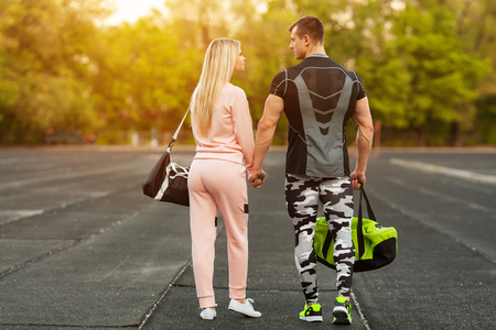 Sporty couple in sportswear together walking in the stadium. Athletic man and womanの写真素材