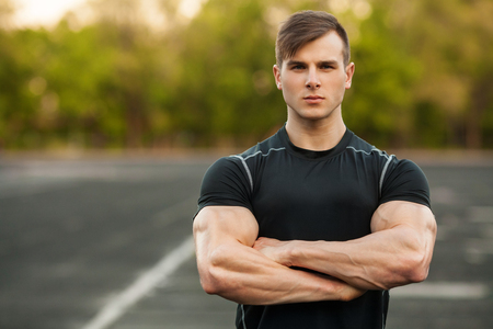 Portrait of handsome sports man in sportswear outdoor. Athletic male outsideの写真素材