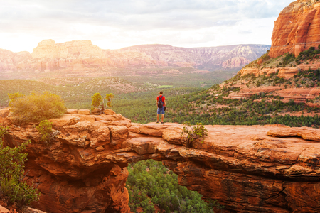 Travel in Devil's Bridge Trail, man Hiker with backpack enjoying view, Sedona, Arizona, USAの写真素材
