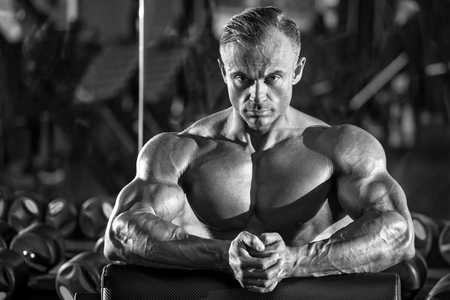 Handsome muscular man in gym, working out. Strong bodybuilder maleの写真素材