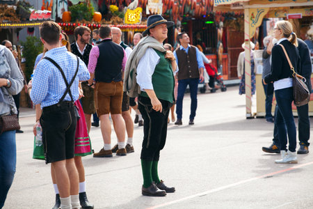 Munich, Germany-September 27, 2017: Man in traditional bavarian clothes leather pants walk on the Oktoberfestのeditorial素材