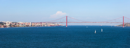 Panorama view over the 25 de Abril Bridge. The bridge is connecting the city of Lisbon to the municipality of Almada on the left bank of the Tejo river, Lisbonの写真素材