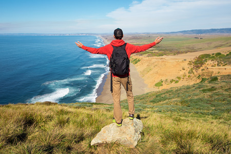 Travel in Point Reyes National Seashore, man Hiker with backpack enjoying view, California, USAの写真素材