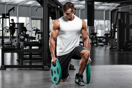 Muscular man working out in gym doing exercise, strong male bodybuilderの写真素材