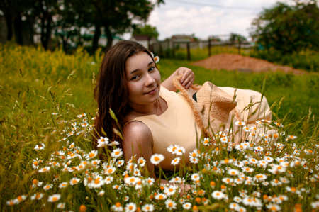 Close Up Portrait Of Lovely Young Romantic Woman Lies In Chamomile Flower Field
