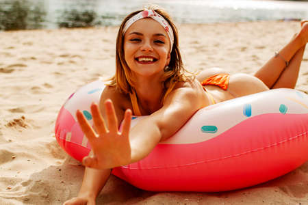 Young sexy fashion woman in yellow swimsuit with well-groomed skin tans on the beachの写真素材