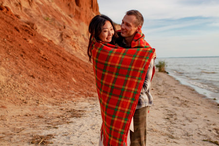 Romantic Happy Multi-Ethnic Couple Chinese Woman And Caucasian Man On Beach In Love At Sunset
