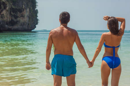 Romantic Happy Multi-Ethnic Couple On Beach In Love At Sunsetの写真素材