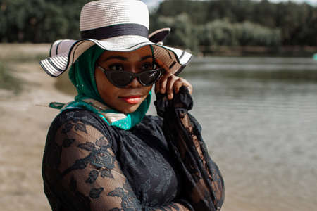 African Woman In Muslim Clothes Near Lake Enjoys The Beautiful Nature