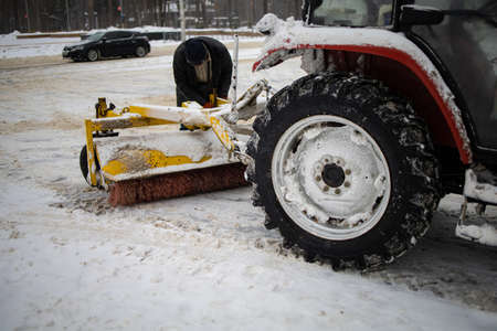 Tractor Cleans Snow With A Brush On The City Avenue.の写真素材
