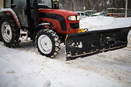 Tractor Cleans Snow With A Brush On The City Avenue.の写真素材
