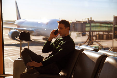 Happy business man waiting for his fligh in airport.の写真素材