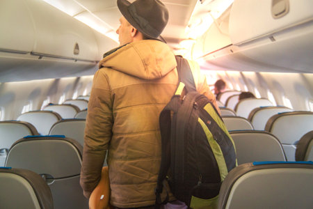 Handsome Young Man In Plane. The Passenger Traveler In Airplane, Travel By Flight, Man Tourist Sitting In Airの写真素材