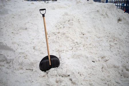 Big Black Plastic Shovel For Snow Cleaning Sticks Out In A Snowdriftの写真素材