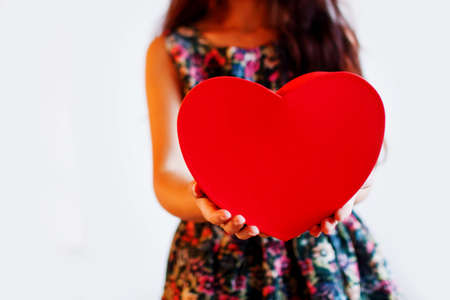 Cute Young Woman Holding Red Heartの写真素材