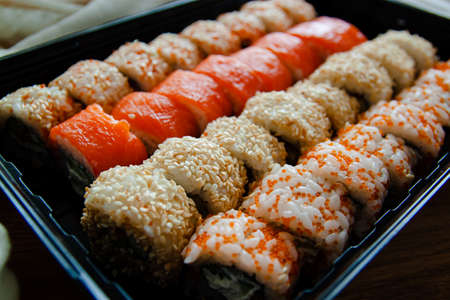 Set Of Assorted Sushi Served Plastic Box On Table. Food Delivery