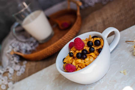 Bowl Of Cereal Flakes With Berries And Milk For Breakfast.の写真素材