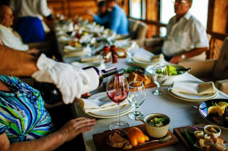 luxury banquet table setting in restaurant close-up. Plates and dishes on dining table in big hall.の写真素材