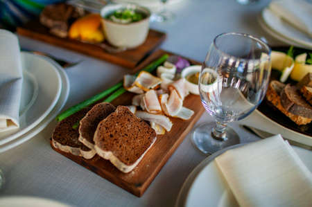Black bread with lard on a wooden board. National russian food.の写真素材