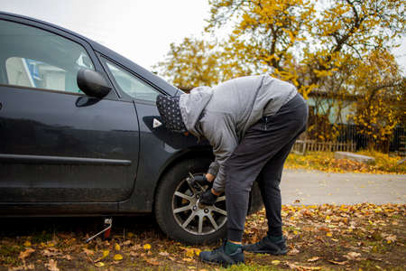 The driver changes the wheel of the car. Change summer wheels for winter.の写真素材