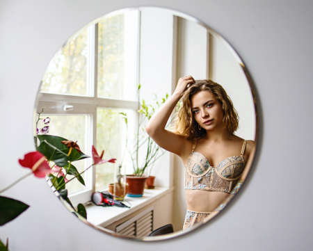 Sexy Beautiful Caucasian Blonde Woman Smiling In Mirrorの写真素材