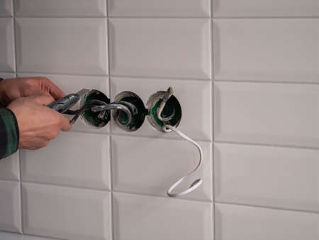 Electrician Installing Wall Socket In New House