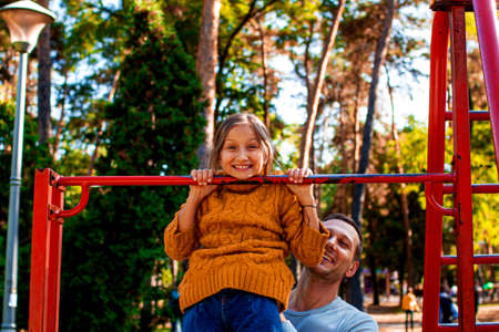 Father and daughter on yoga mat smiling. Health family do pilates. Family doing sports, doing exercises at home.の写真素材