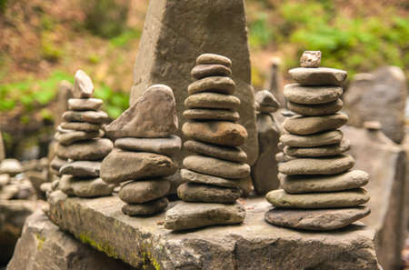 Stones pyramid on pebble beach symbolizing stability, zen, harmony, balance. Shallow depth of field.の写真素材